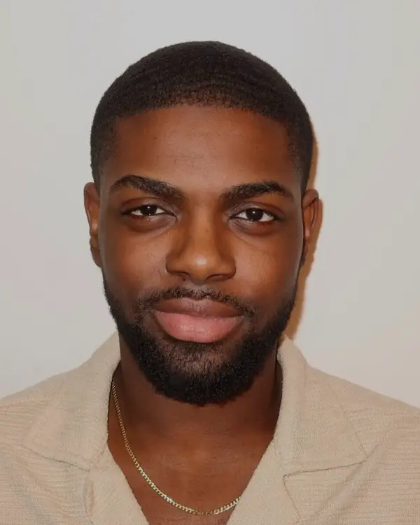 David Smith smiling, in a cream shirt
